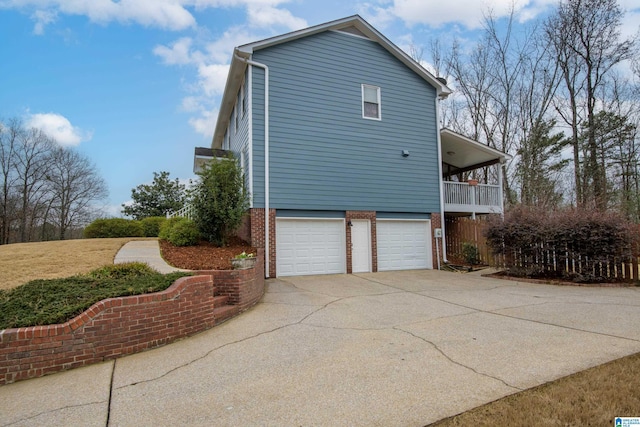 view of home's exterior featuring a garage and a balcony