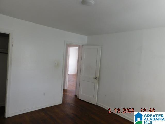 unfurnished bedroom featuring dark hardwood / wood-style floors