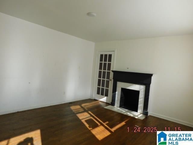 unfurnished living room featuring dark hardwood / wood-style flooring