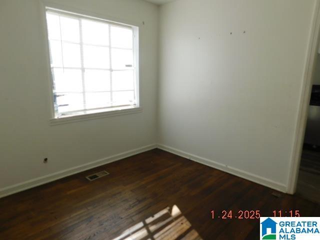 spare room with dark hardwood / wood-style flooring