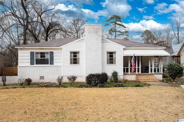 rear view of house with a yard and covered porch