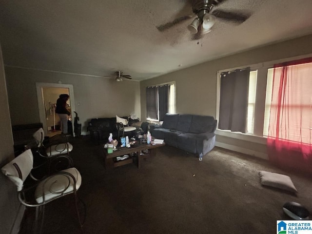 living room with ceiling fan, carpet, and a textured ceiling