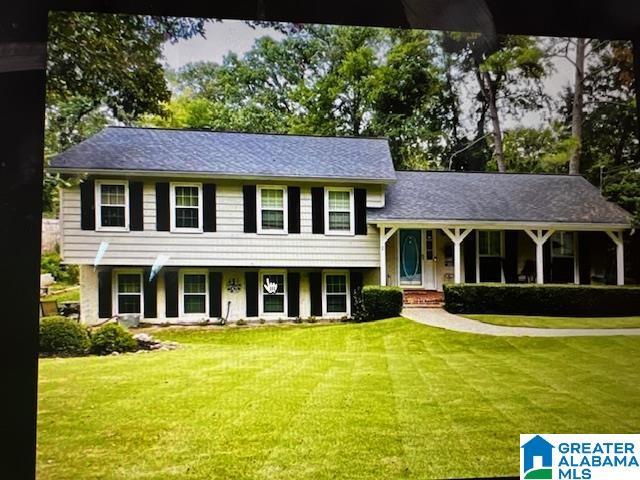 tri-level home featuring a front lawn