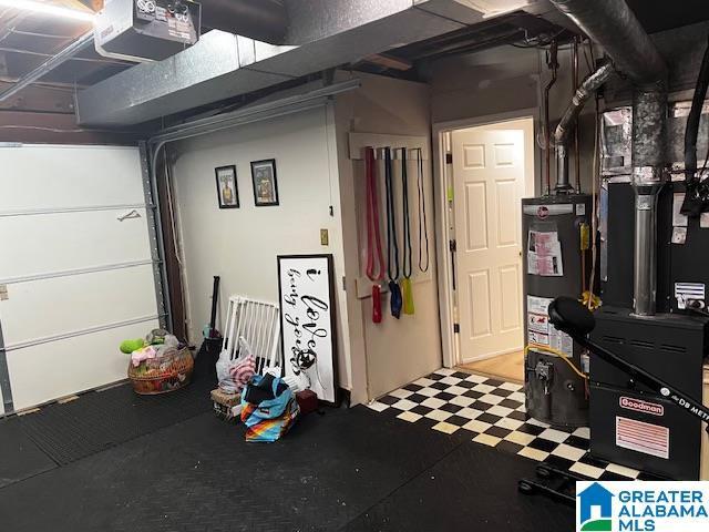 garage featuring a garage door opener and water heater