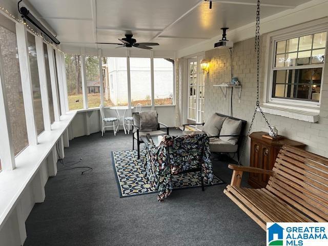 sunroom / solarium featuring ceiling fan