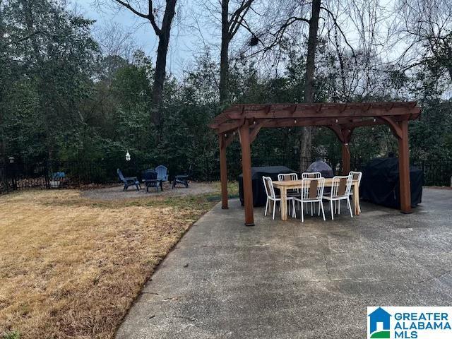 view of patio featuring a pergola and a fire pit