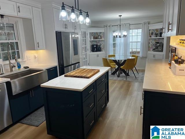 kitchen with white cabinets, appliances with stainless steel finishes, and a kitchen island