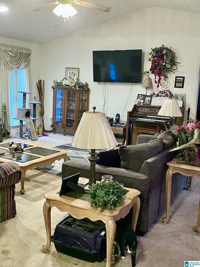 living room with vaulted ceiling, ceiling fan, and carpet flooring