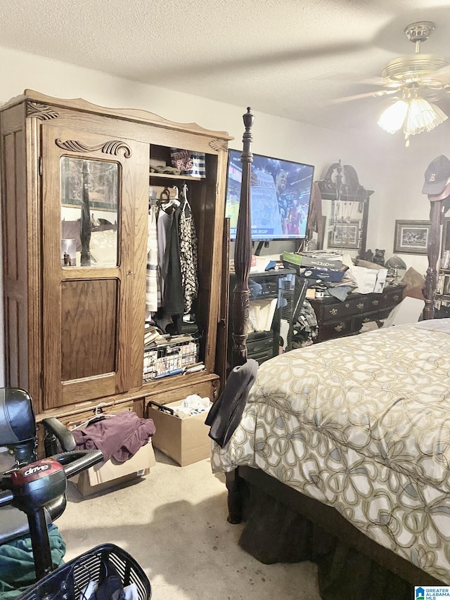 bedroom featuring ceiling fan, a textured ceiling, and carpet flooring