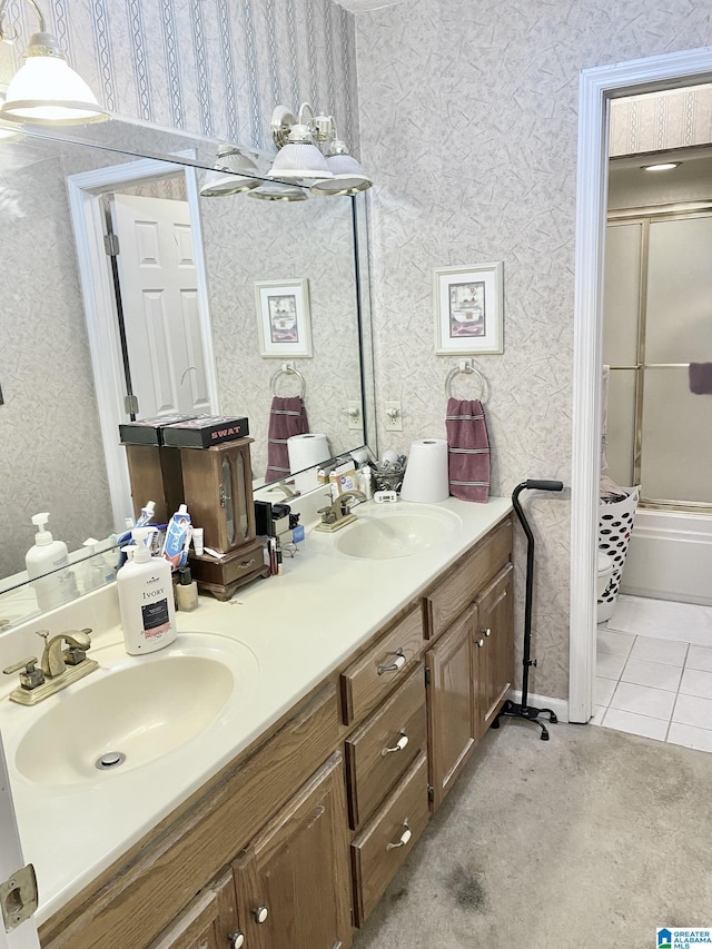 bathroom with tile patterned floors, bath / shower combo with glass door, and vanity