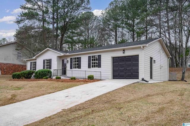 ranch-style house featuring a garage and a front lawn