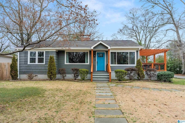 view of front facade featuring a front yard and a pergola