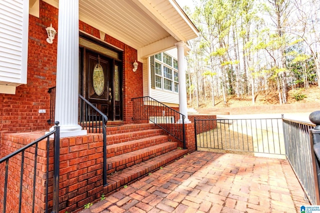 entrance to property featuring brick siding