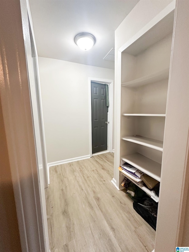 corridor featuring light hardwood / wood-style floors