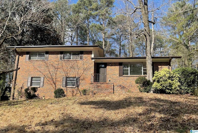 tri-level home featuring crawl space and brick siding