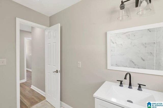 bathroom with vanity and baseboards