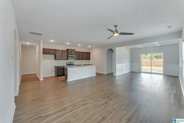 unfurnished living room featuring sink, wood-type flooring, and ceiling fan