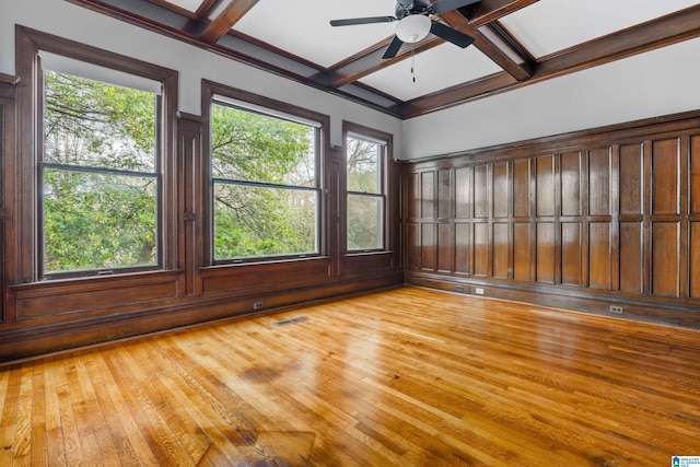 interior space with beamed ceiling, plenty of natural light, and coffered ceiling