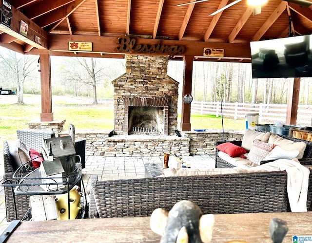 view of patio / terrace featuring a gazebo and an outdoor living space with a fireplace