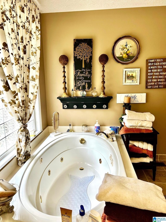 bathroom with tile patterned flooring and a relaxing tiled tub