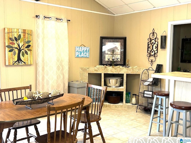 tiled dining area featuring lofted ceiling