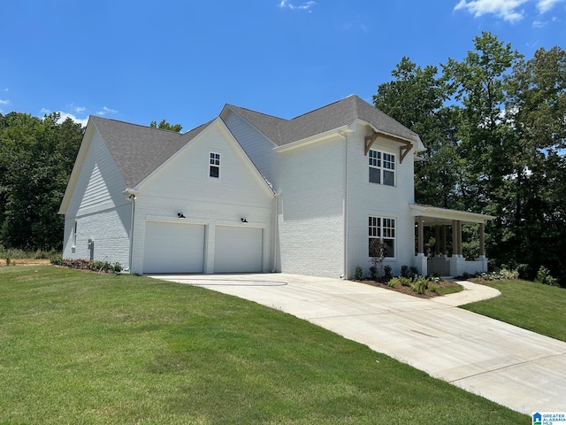 view of front of home with a garage and a front lawn