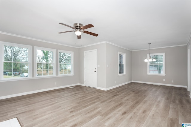 interior space featuring crown molding, ceiling fan with notable chandelier, and hardwood / wood-style floors