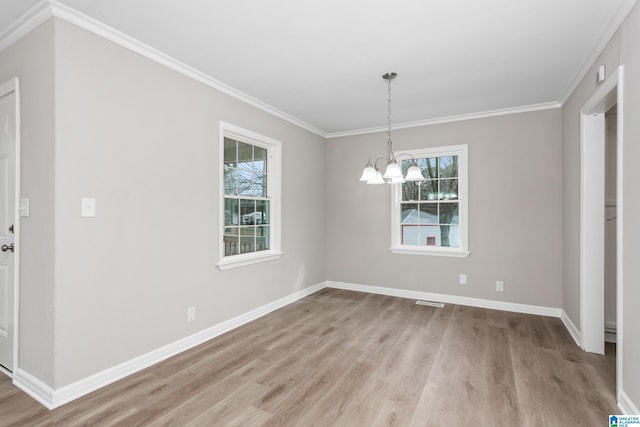 unfurnished dining area featuring ornamental molding, a wealth of natural light, an inviting chandelier, and light hardwood / wood-style floors