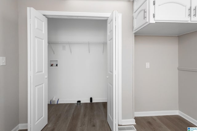 washroom with hookup for a washing machine and dark wood-type flooring