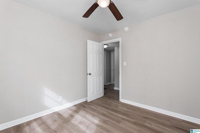 unfurnished room with hardwood / wood-style floors and ceiling fan