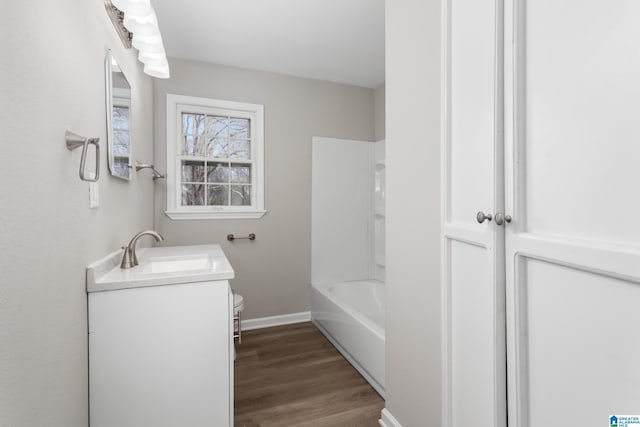 full bathroom featuring shower / bath combination, vanity, hardwood / wood-style floors, and toilet