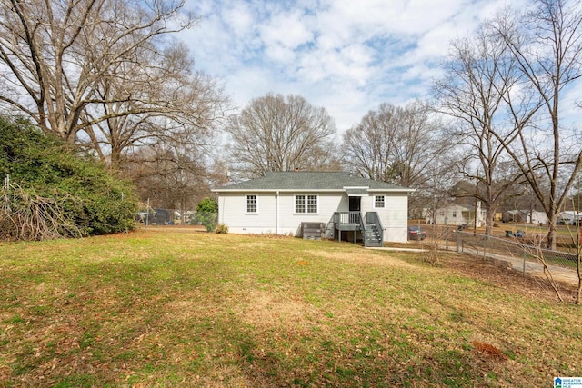 back of house featuring a lawn and central air condition unit