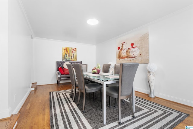 dining room with wood-type flooring and ornamental molding