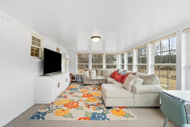 living room featuring brick wall and light carpet