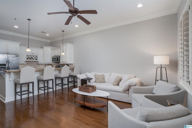 living room featuring recessed lighting, dark wood finished floors, a ceiling fan, and ornamental molding