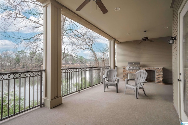 balcony featuring a grill, exterior kitchen, and a ceiling fan