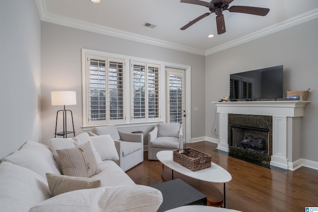 living room with visible vents, dark wood-style flooring, and ornamental molding