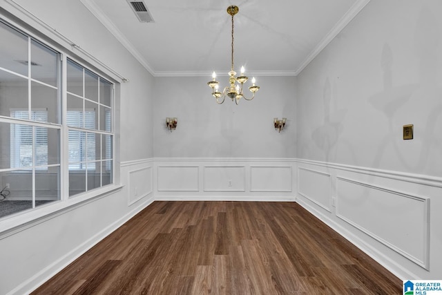 unfurnished dining area featuring crown molding, a chandelier, and dark wood-type flooring