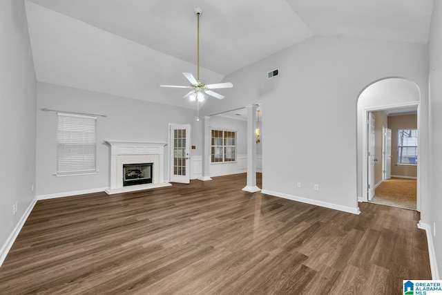 unfurnished living room with dark wood-type flooring, high vaulted ceiling, and ceiling fan