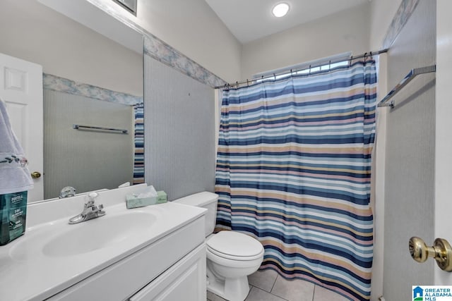 bathroom with toilet, vanity, tile patterned flooring, and curtained shower