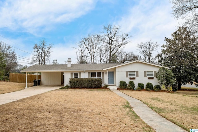 ranch-style house featuring a carport and a front lawn