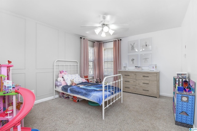 bedroom with light carpet, a ceiling fan, and baseboards