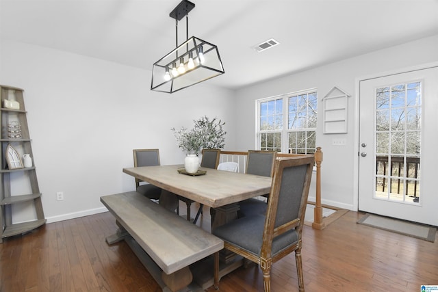 dining area with visible vents, baseboards, and dark wood-style flooring