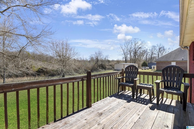 wooden deck featuring a lawn