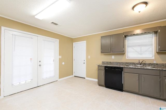 kitchen featuring stone counters, dishwasher, sink, and a textured ceiling