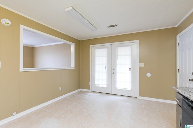 entryway with french doors, crown molding, and light tile patterned floors