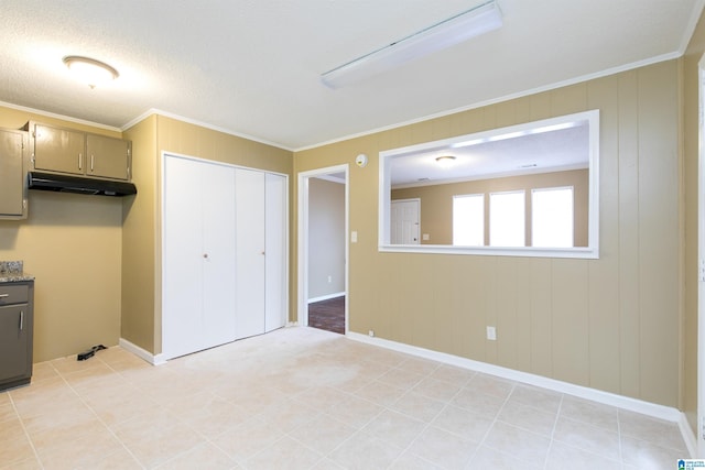 interior space with ornamental molding and light tile patterned floors