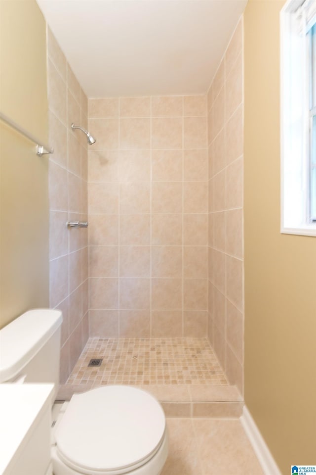 bathroom featuring vanity, toilet, and tiled shower