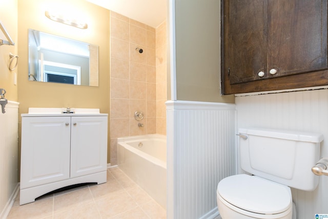 full bathroom with tile patterned flooring, vanity, tiled shower / bath combo, and toilet