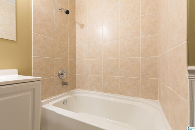 bathroom featuring vanity and tiled shower / bath